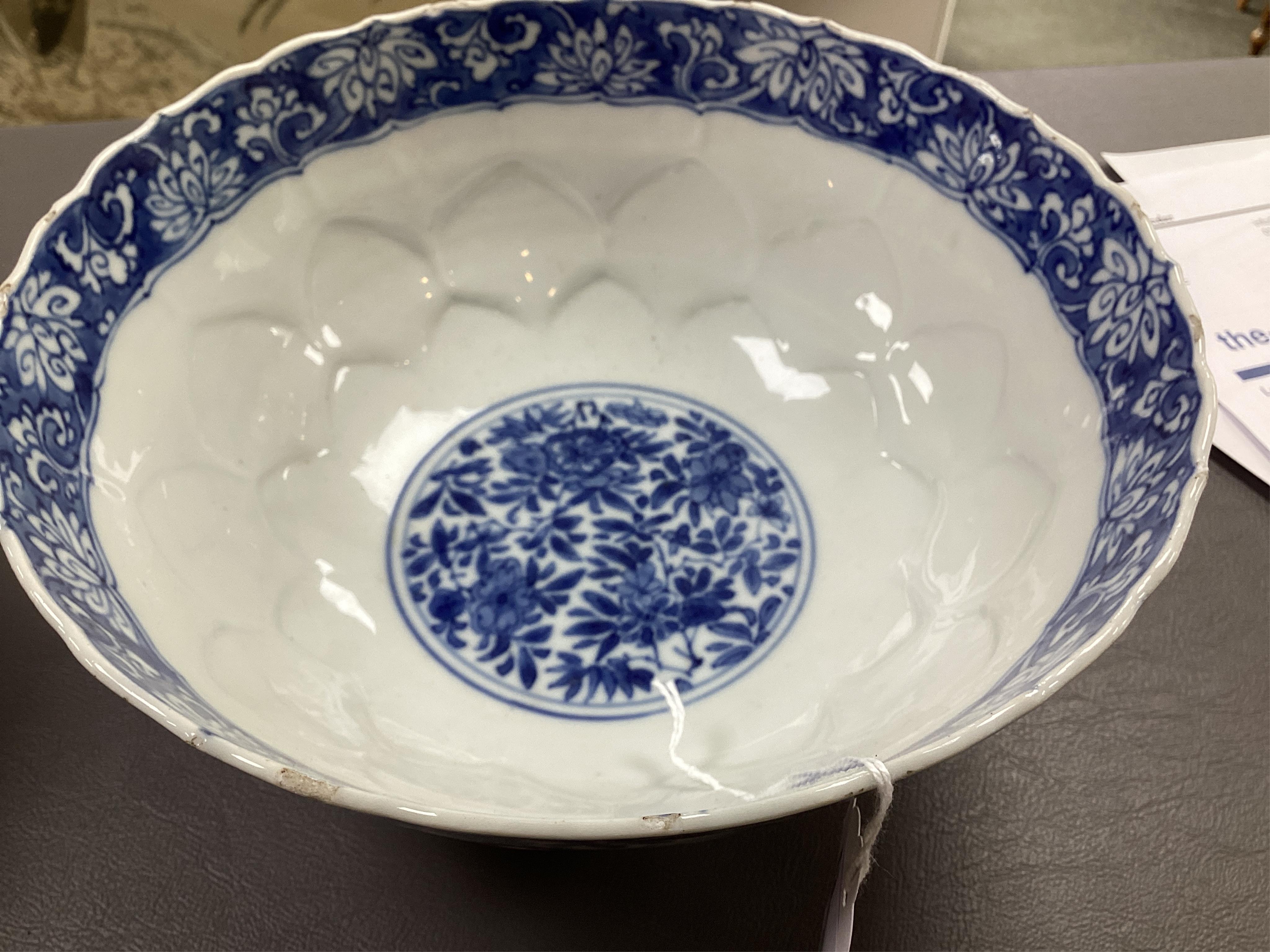 A near pair of Chinese blue and white lotus flower moulded bowls, Kangxi period